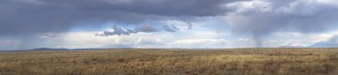 Storm clouds gathering over Route 66 in Arizona clipart