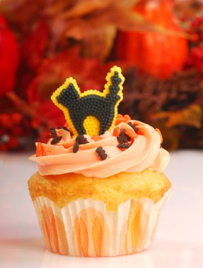 Halloween cupcake with fall foliage clipart