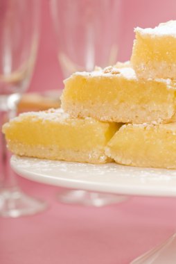 Lemon squares on a white cake stand clipart