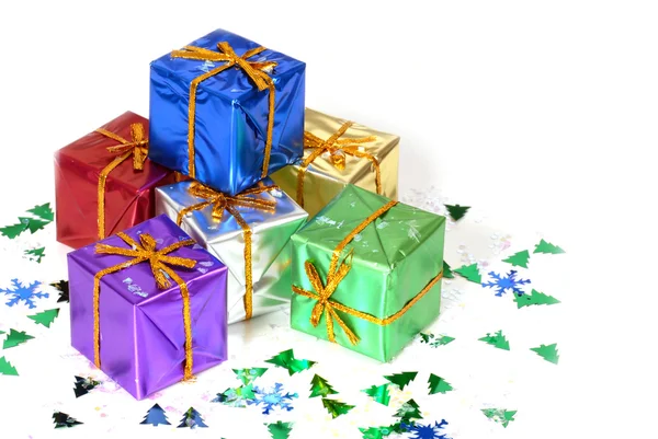 Six brightly colored wrapped Christmas presents — Stock Photo, Image