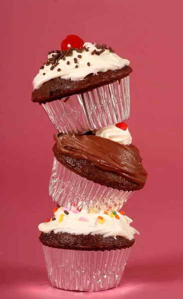 Three chocolate cupcakes stacked on end — Stock Photo, Image