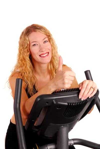 Attractive woman on exercise bike — Stock Photo, Image