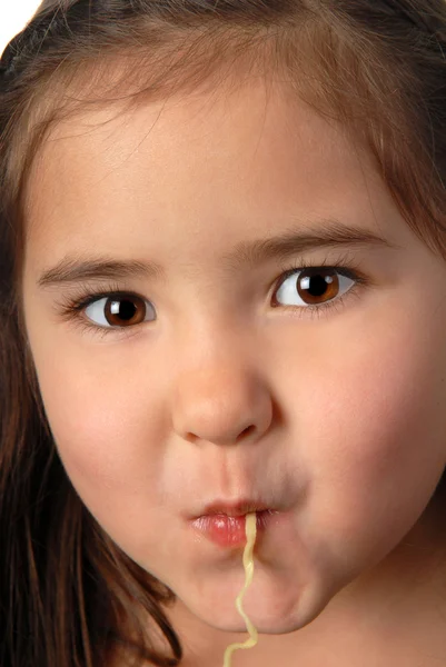 Young girl slurping a noodle — Stock Photo, Image