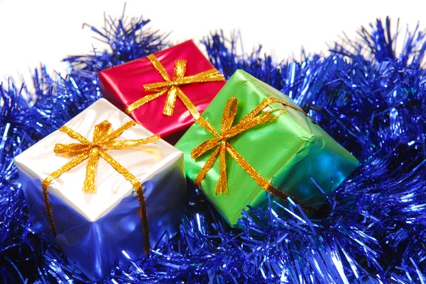 Several colorful Christmas presents on garland — Stock Photo, Image