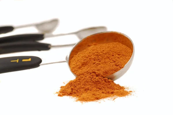 stock image Ground cinnamon in a measuring spoon