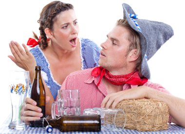 Drunk man with his wife in traditional dresses clipart