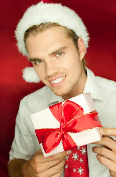 Holding a gift with a smile — Stock Photo, Image