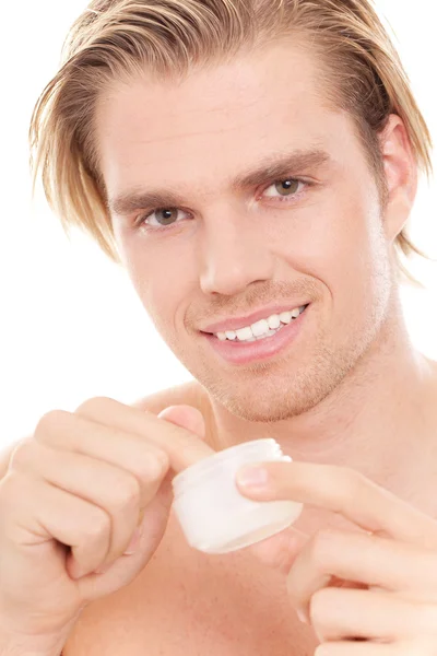 Man with finger in creme — Stock Photo, Image