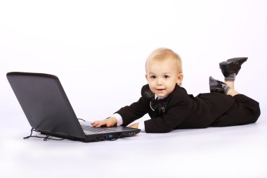 Boy in a tuxedo with a laptop