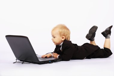 Boy in a tuxedo with a laptop