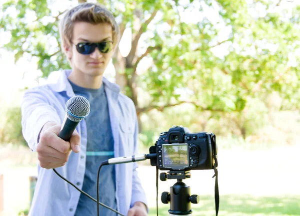 Stock image Holding Microphone