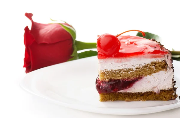 Egy szelet tortát és egy vörös rózsa — Stock Fotó