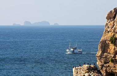 Trawler in the Sea of Peniche clipart