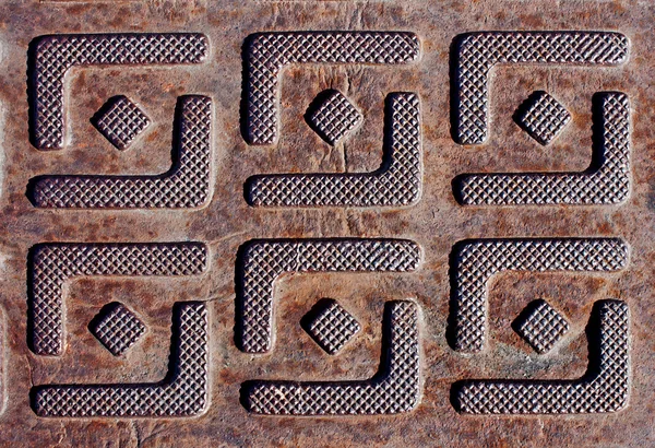 Metallplattan med präglad av kvadratiska mönster Royaltyfria Stockfoton