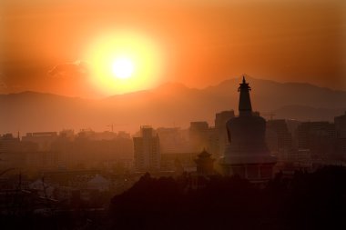 Beihai Stupa with Sunset and Mountains Beijing China clipart