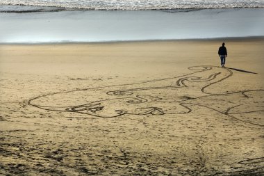 Woman Sand Painting Beach Walking to Water San Francisco Califor clipart