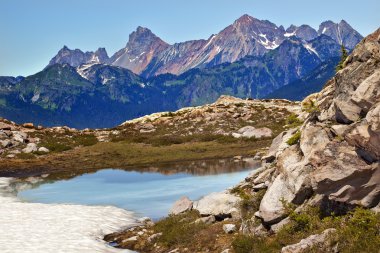 Red Mountains Small Blue Snow Pool Artist Point Washington State clipart