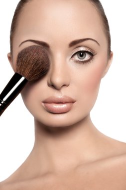 Portrait of a beautiful woman with a make up brush clipart