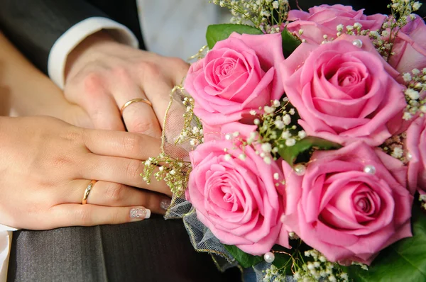 Wedding Bouquet with hands and rings Royalty Free Stock Photos