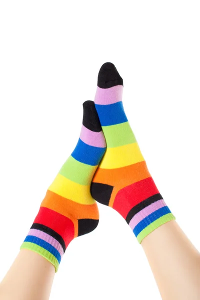 Foots in stripped socks over white — Stock Photo, Image