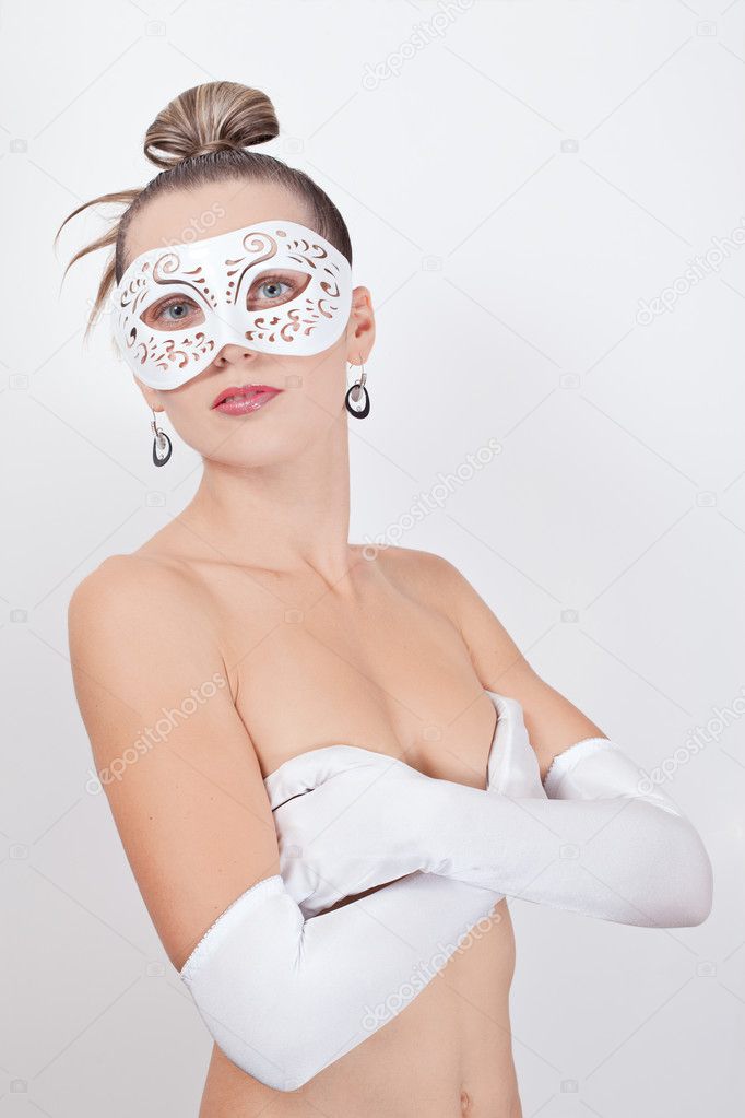 Portrait of woman in latex gloves and venetian mask over white background
