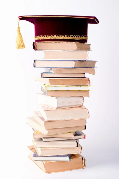 Maste's cap with a books — Stock Photo, Image