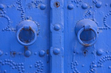 Oriental beautiful blue knocker and traditional door in Tunisia clipart