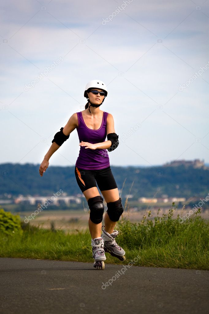 Young woman on rollerblades in the country