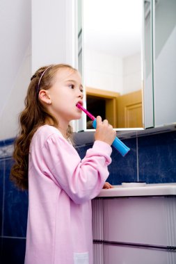 Girl brushing teeth clipart