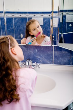 Girl brushing teeth clipart