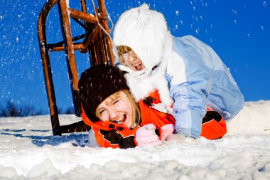 Girls crashing at sledding clipart