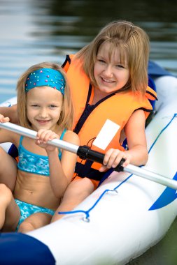 Two young girls at a lake clipart