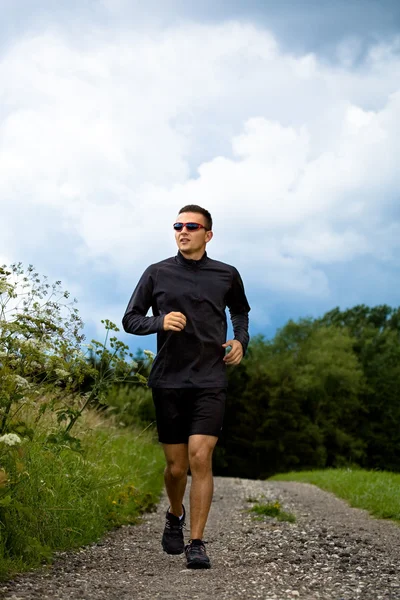 Jogging through the fields — Stock Photo, Image