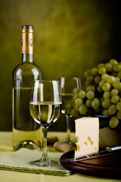 Wine bottle and cheese — Stock Photo, Image