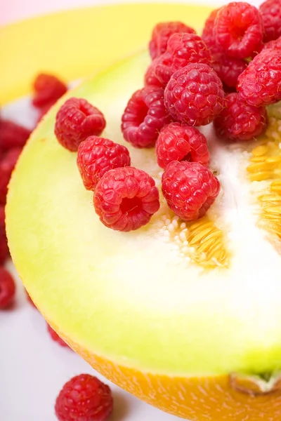 Raspberries and melon — Stock Photo, Image