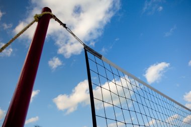 Net on beach and clouds clipart