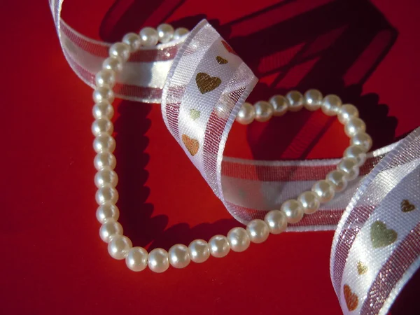 Beads, ribbon and hearts — Stock Photo, Image