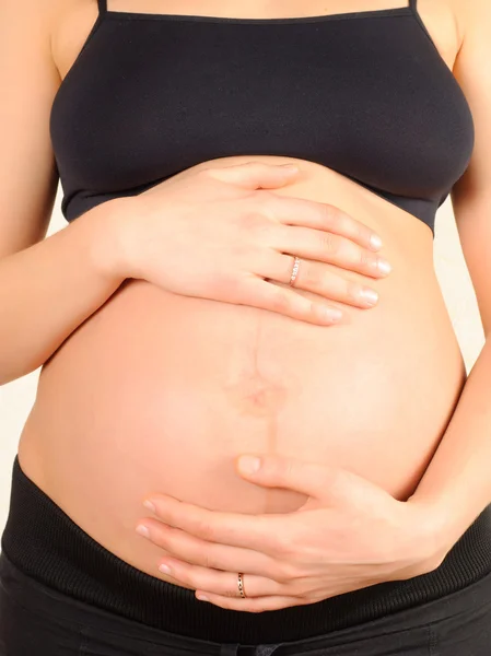 Gravid kvinna isolerad på vit Stockbild