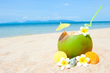 Ocean beach with palm and and exotic coctail clipart