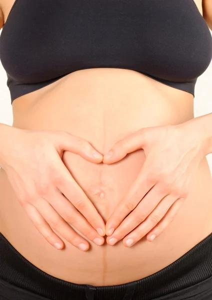 Pregnant woman embracing the belly — Stock Photo, Image