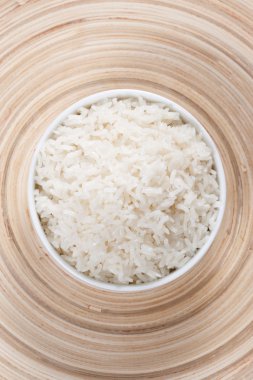 Rice in a bowl on a bamboo plate clipart