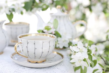 Tea in the blossoming garden clipart