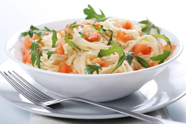 Pasta with tomato and rucola — Stock Photo, Image