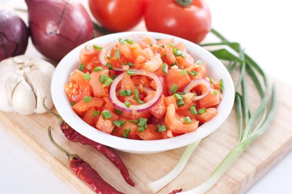 Salsa in a bowl on a wooden board and ingredients — Stock Photo, Image