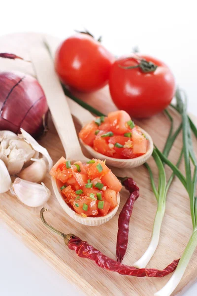 Salsa in two spoons on a wooden board and ingredients — Stock Photo, Image