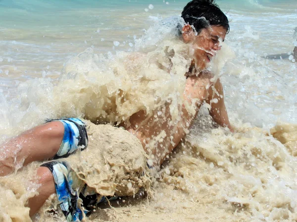 Boy swept by a caribbean surf wave. — Stok fotoğraf