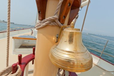 View of the brass bell and mast on the private sail yacht. clipart
