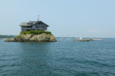 House on the small rocky island in the Newport Harbor. clipart