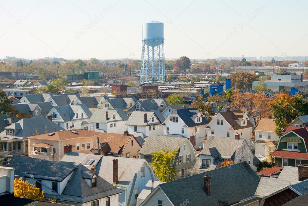 Suburban rooftops and water tower.
