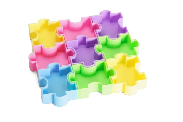 Multicolor plastic jigsaw puzzles — Stock Photo, Image